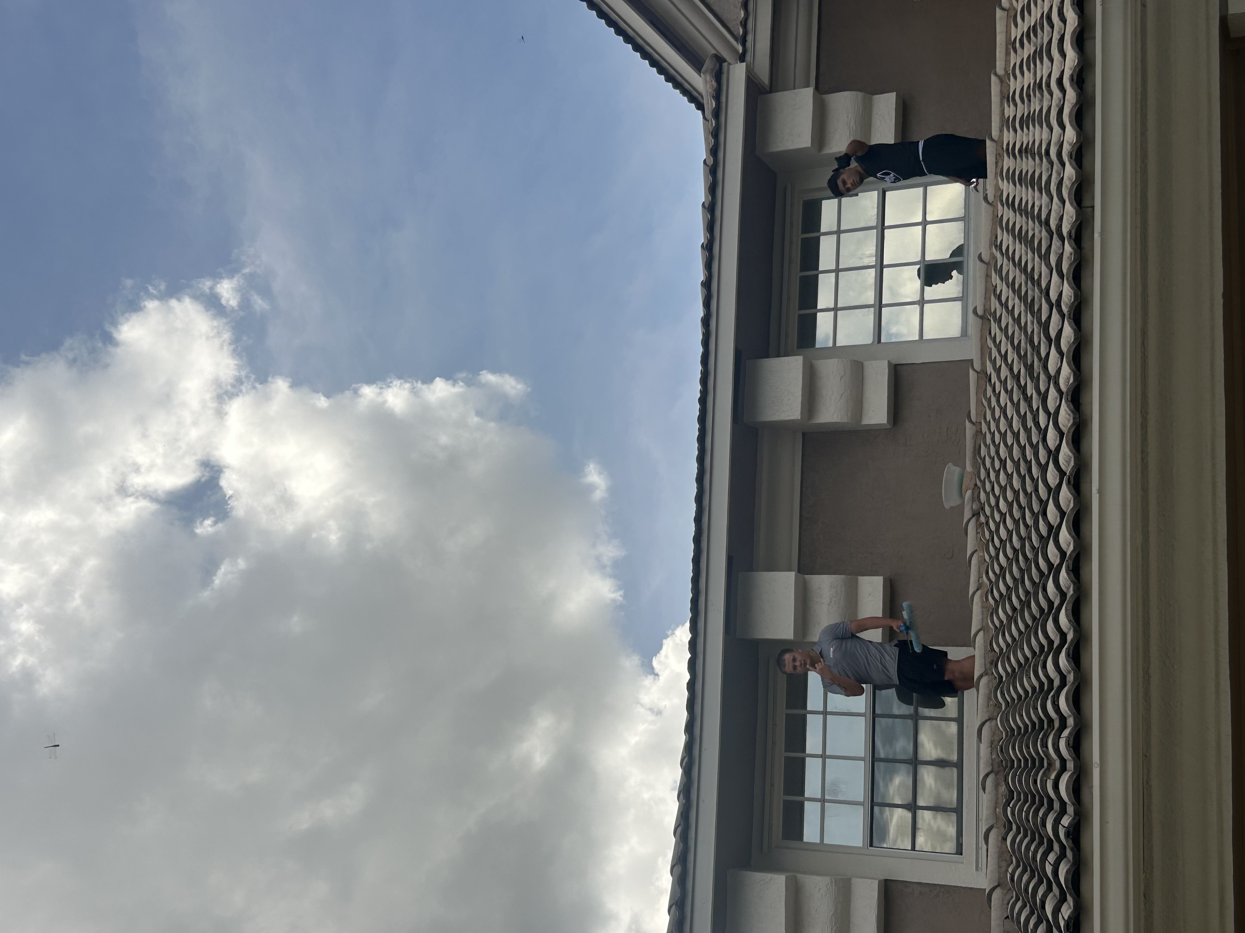 Technician performing professional window cleaning service